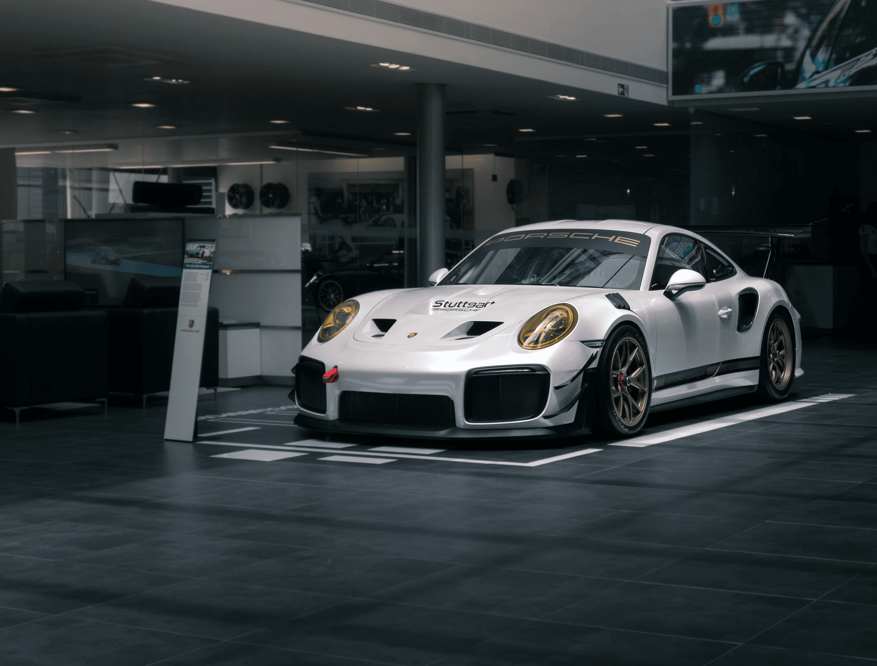 White sports car inside an automotive workshop