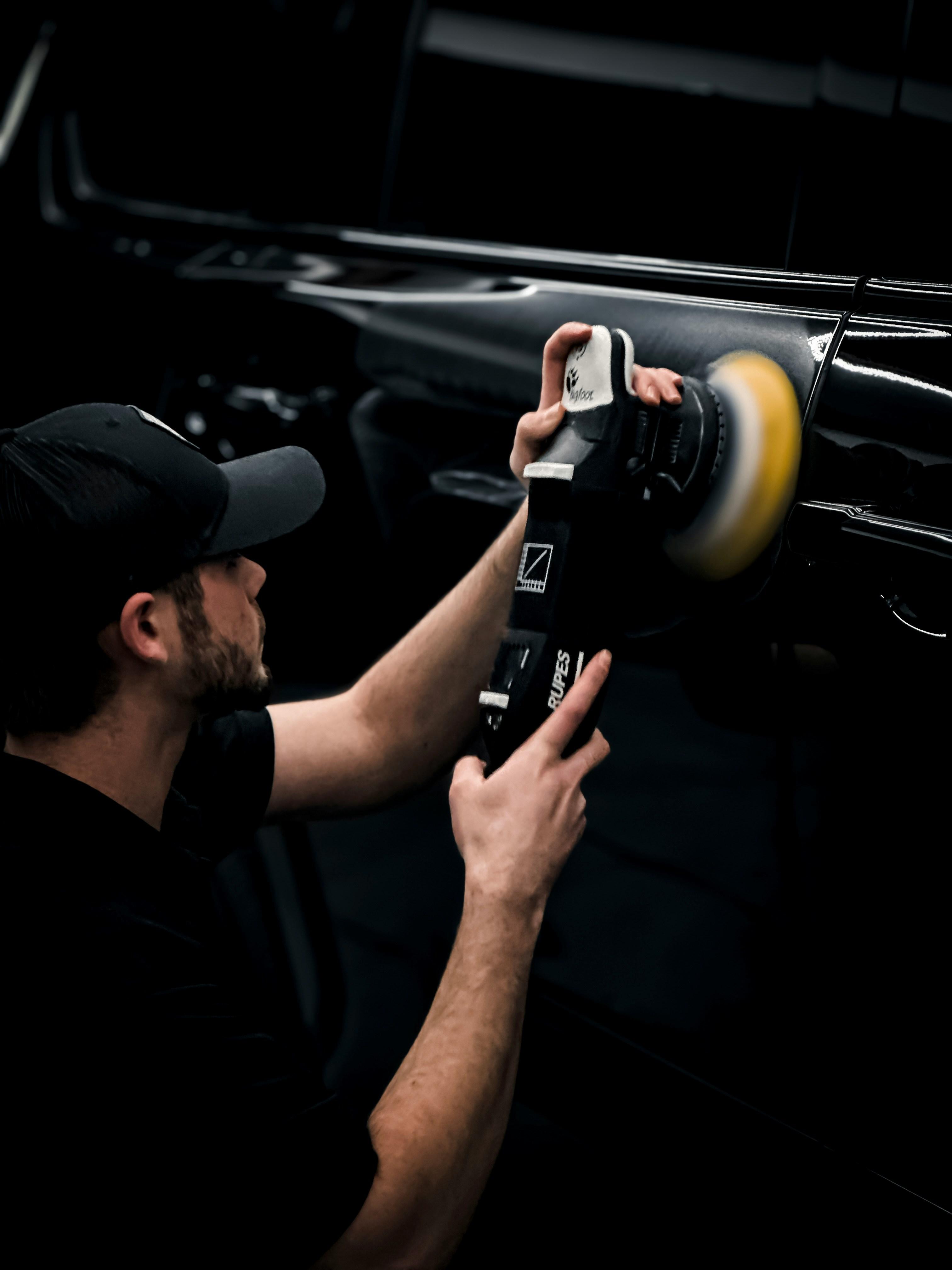 Automotive specialist polishing a vehicle