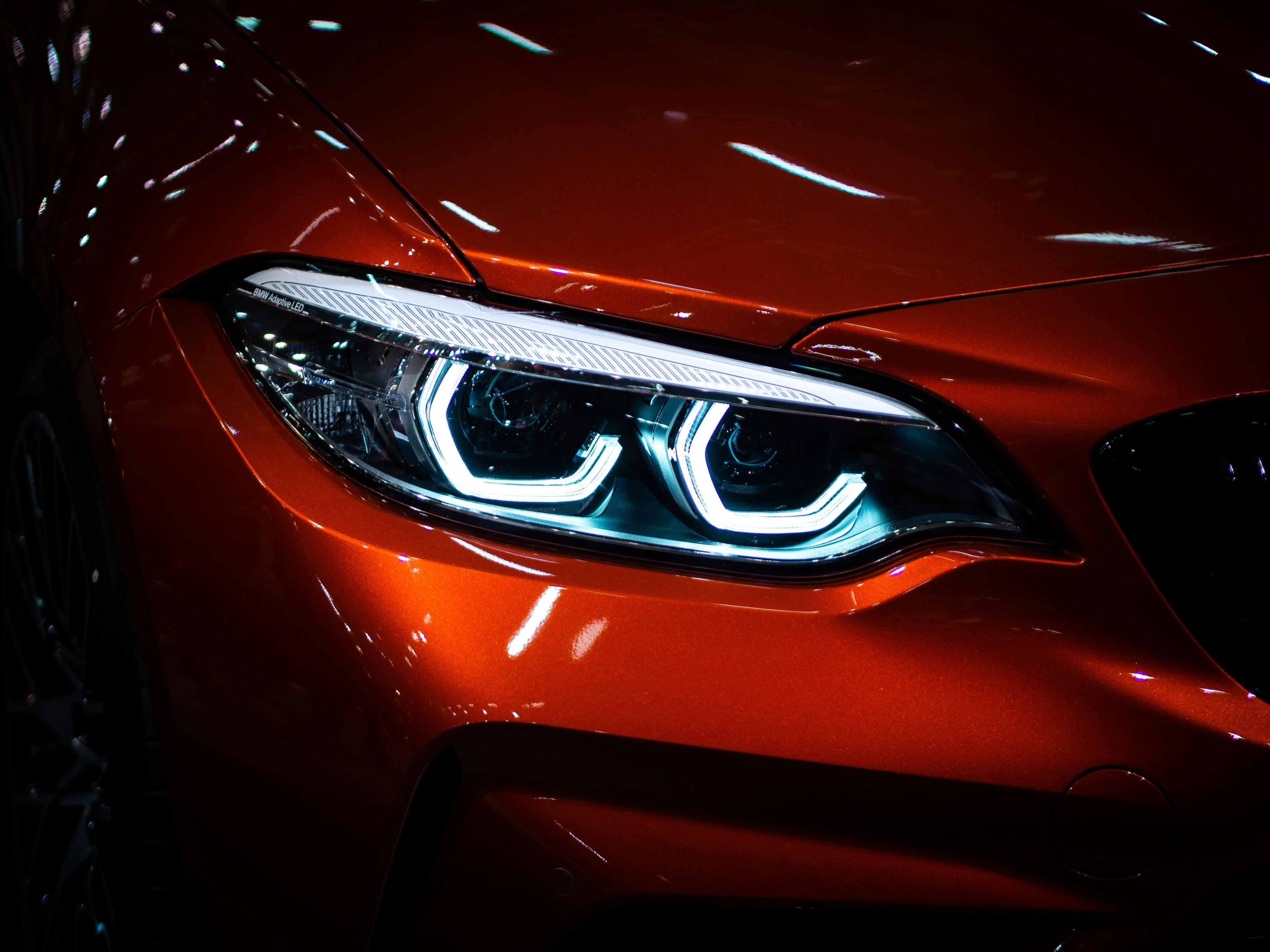 Close-up of a premium orange sports car headlight