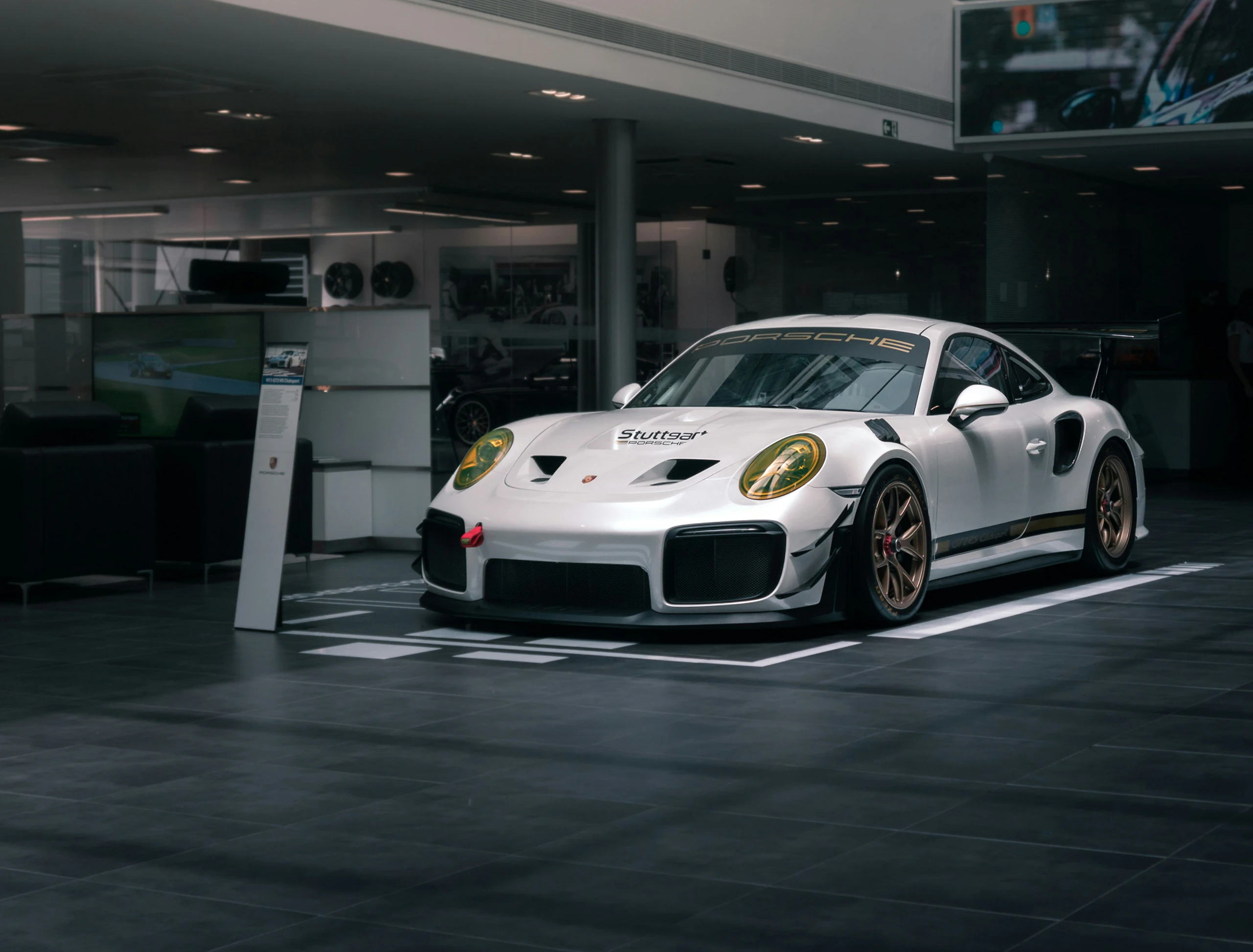 White sports car inside an automotive workshop